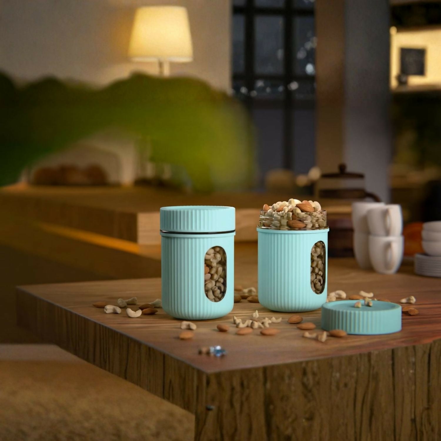 Two airtight food storage containers holding dry fruits and nuts on a kitchen counter
