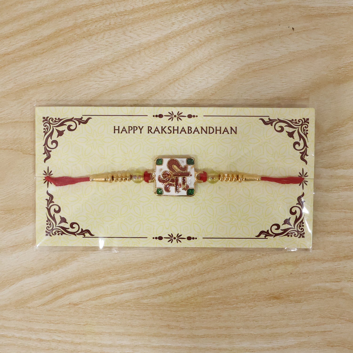 Shree Symbol Square Rakhi with Green Stones and Gold Beads