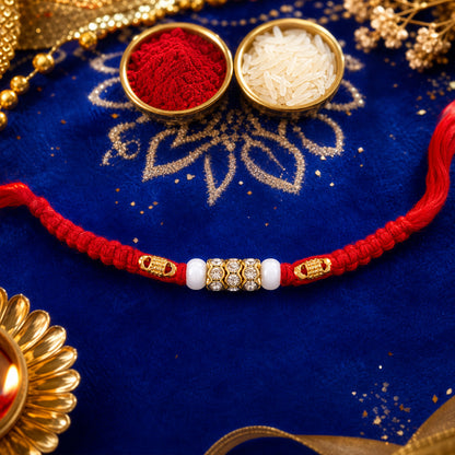 Red Braided Rakhi with White Beads and Antique Gold Accent Charms