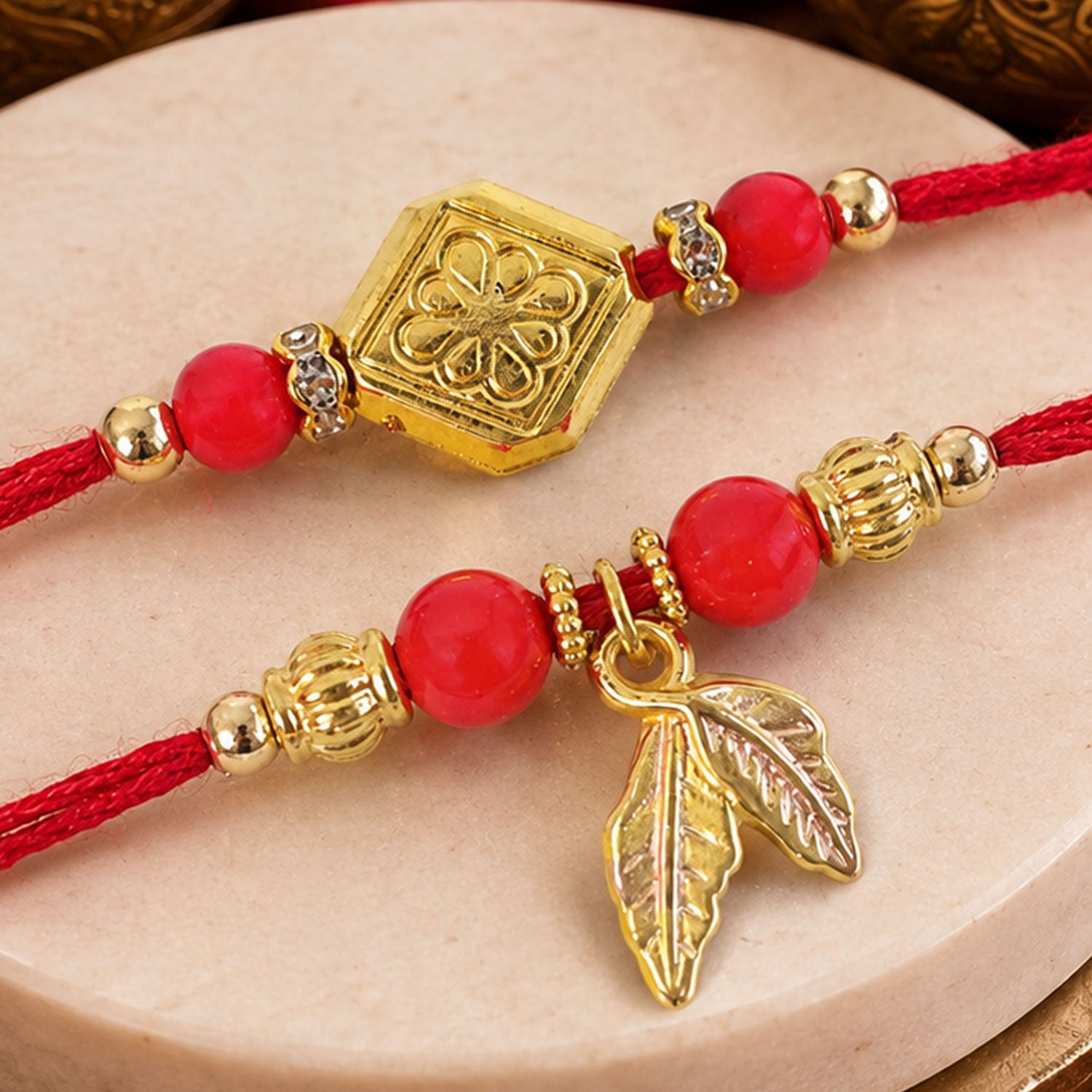 Red Bead Floral Rakhi Pair with Leaf Charms for Bhaiya Bhabhi Couple Celebration
