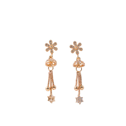 Side view of rose gold drop earrings with crystal encrusted floral star