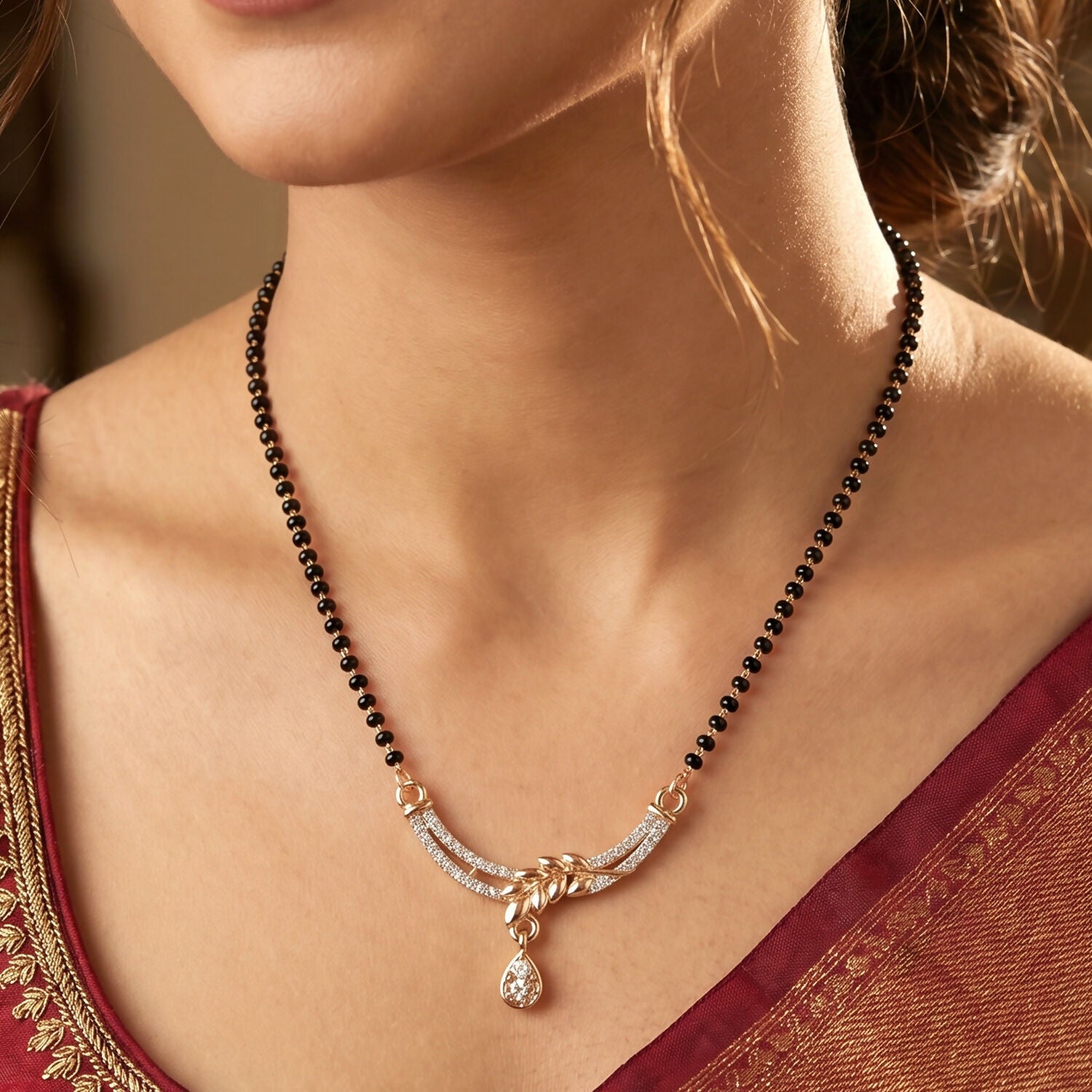 Sparkling stone embellishments on leaf-shaped mangalsutra pendant