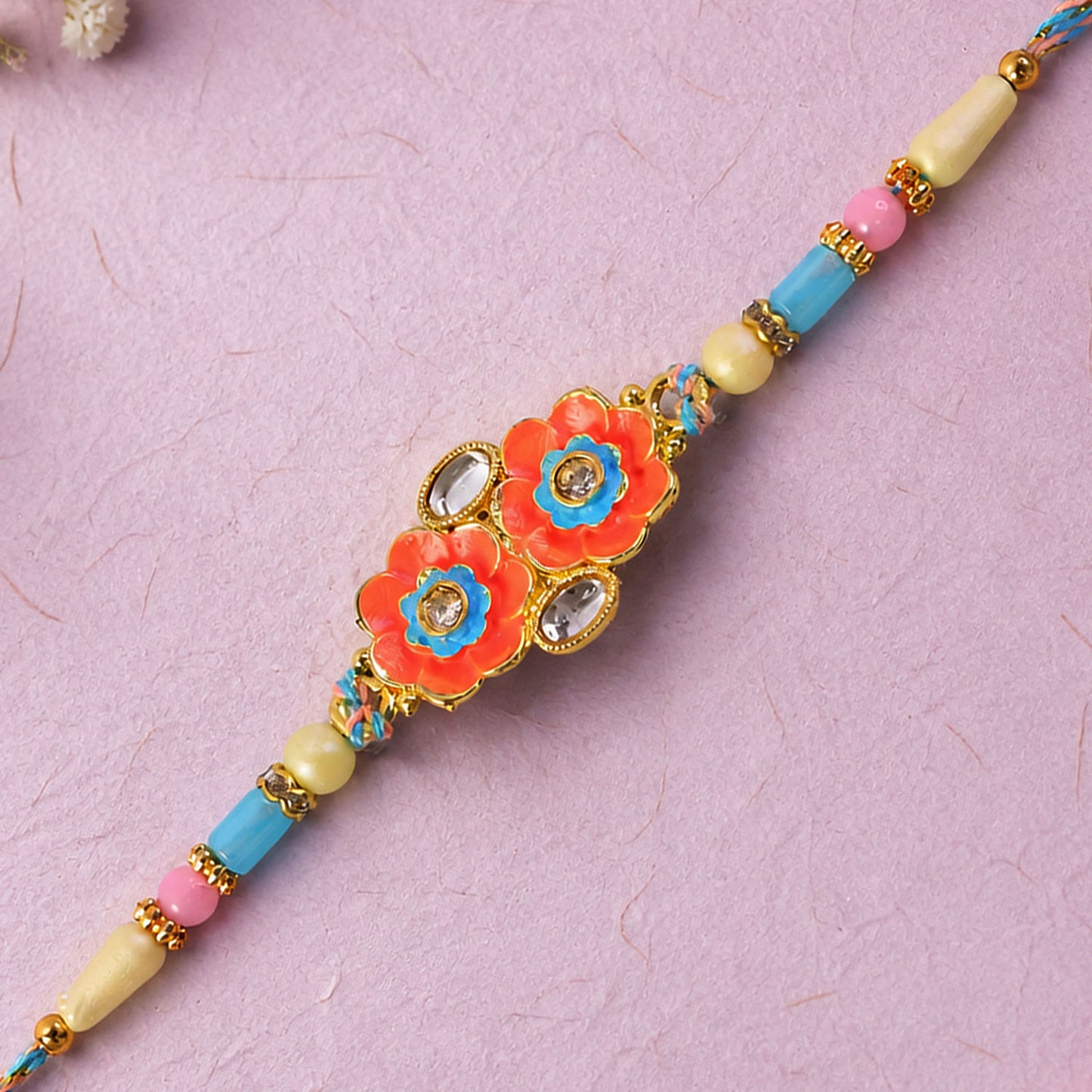 Ornate Rakhi with Butterfly Bloom Charm, multicolor stones and bead line for Gift Use