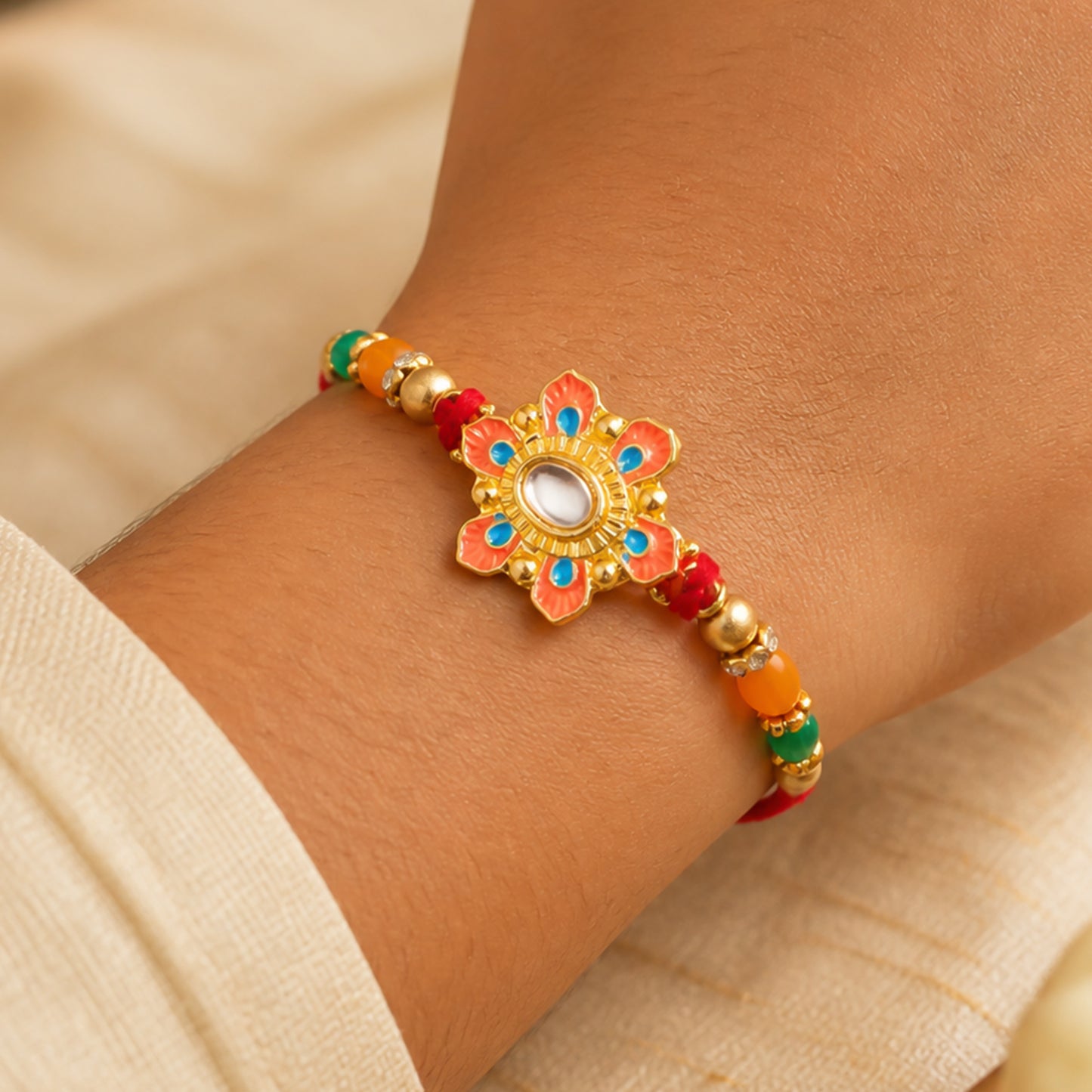 Orange and Teal Floral Kundan Pendant Rakhi with Pastel Beads
