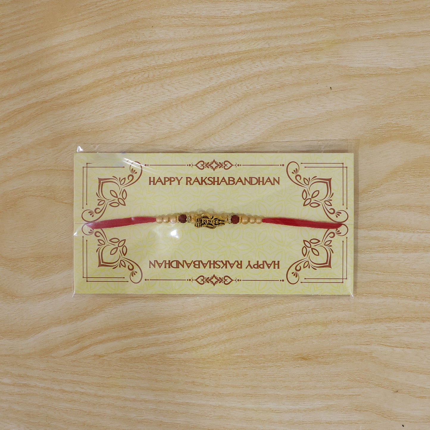 Shiv Trishul Damru Devotional Rakhi with Engraved Shiv Word, Golden Plate and Red Stones