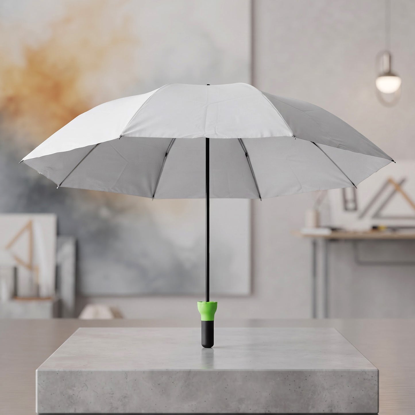 Open grey umbrella with a black shaft and bright green handle standing upright on a concrete block.