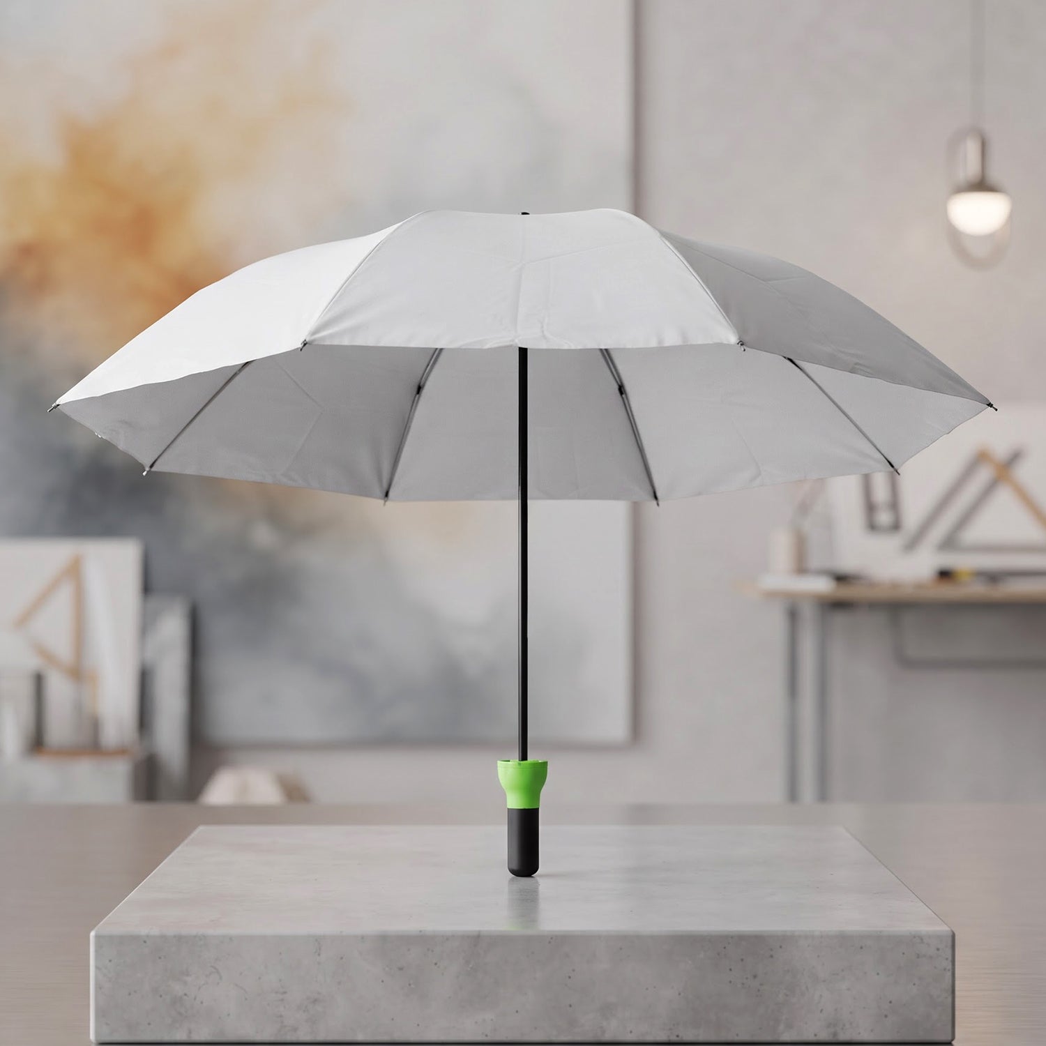 Open grey umbrella with a black shaft and bright green handle standing upright on a concrete block.