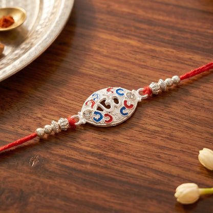Silver Om Rakhi for Boys with Red Thread and Colorful Accents