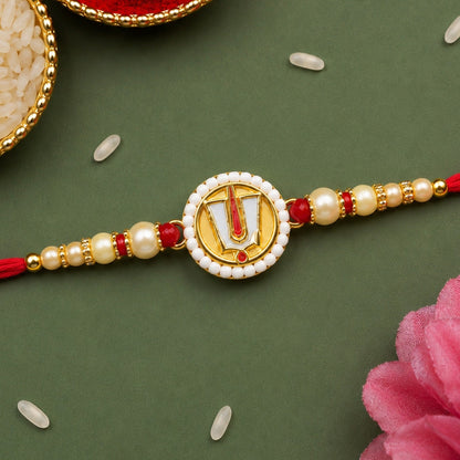 The devotional thread is centered on a dark green background with scattered white rice grains and a pink flower petal.
