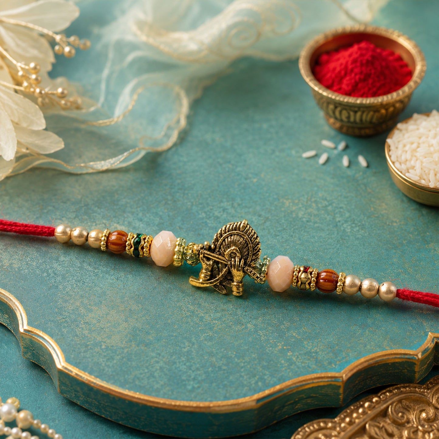 Krishna Flute Peacock Devotional Rakhi with Antique Gold Centre and Peach Beads