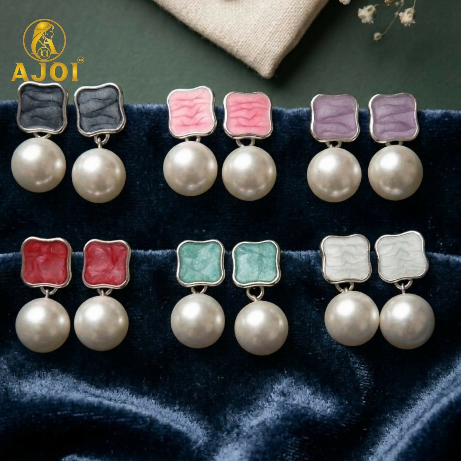 Glossy round pearl drop earrings with sleek metallic finish