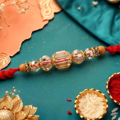 Red Thread Rakhi with Champagne Crystal Beads and Golden Accents