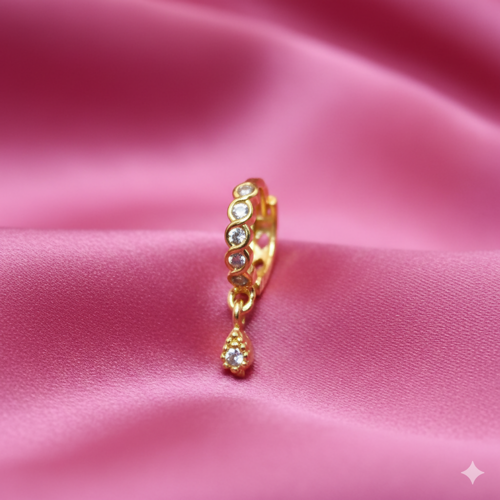 Gold plated crystal drop nosepin with teardrop dangle on white background