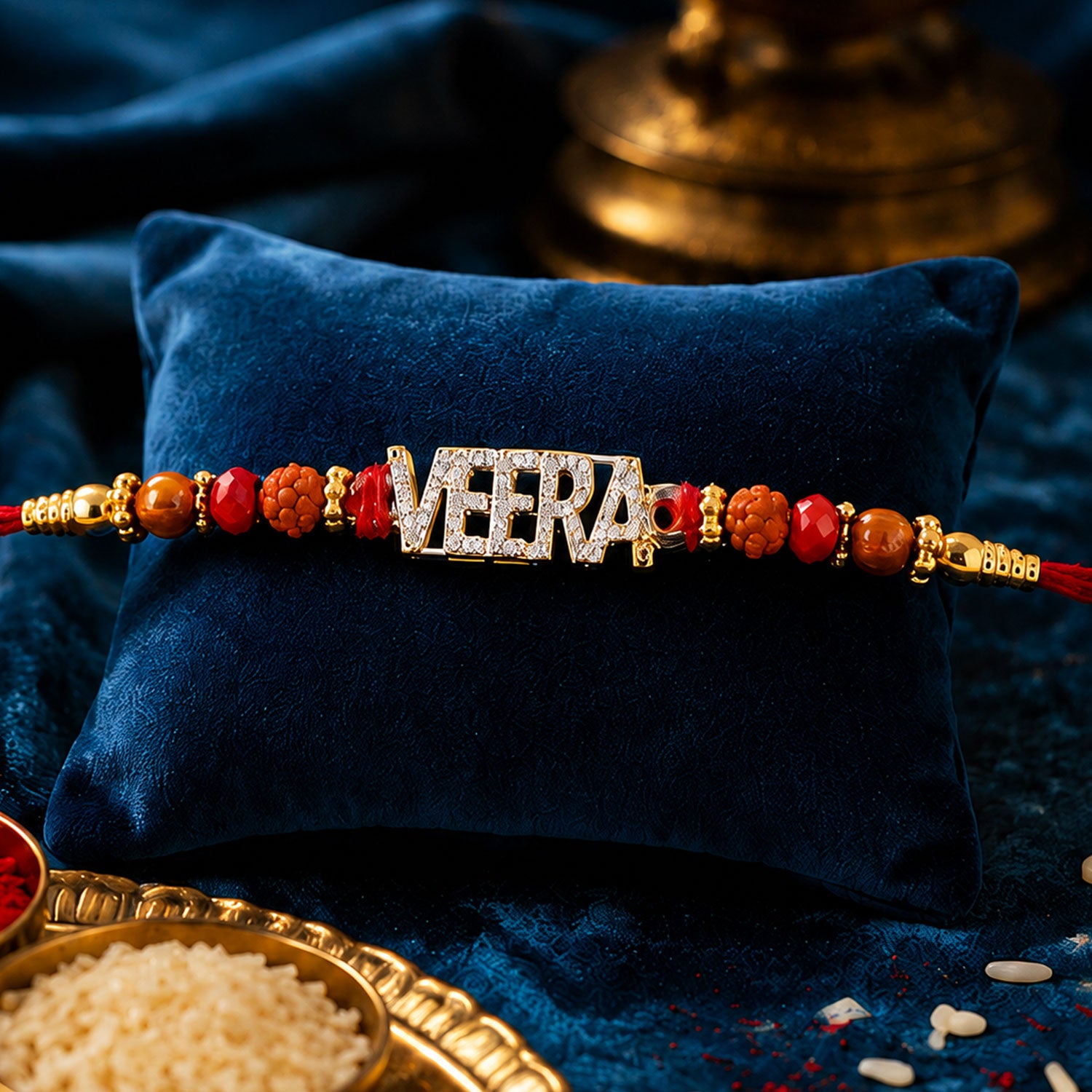 Veera Name Golden Designer Rakhi with Red Stones, Pearl Accents and Festive Beads