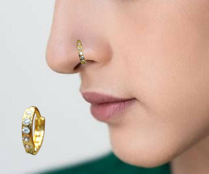 Close-up of gold plated nose ring featuring sparkling cubic zirconia crystals