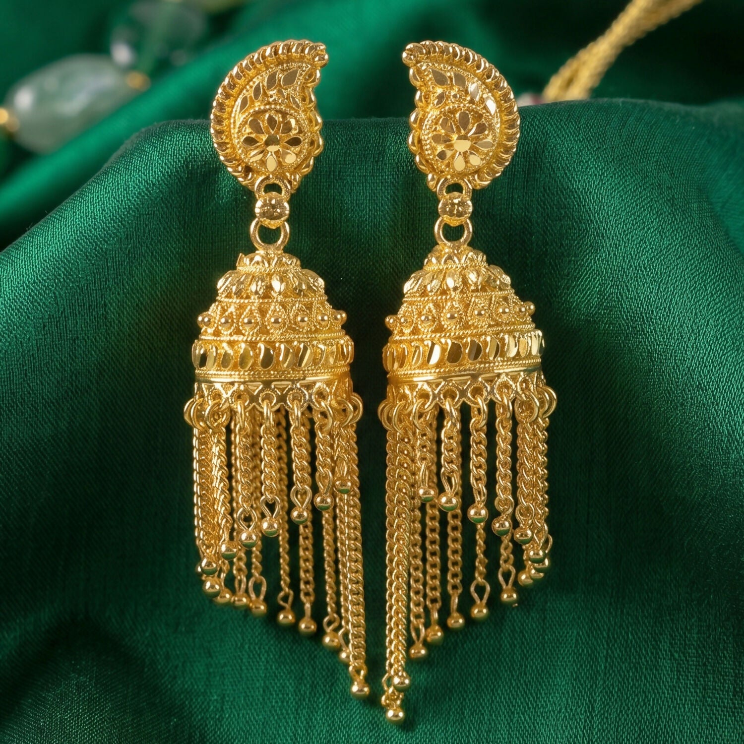 Jhumka earrings highlighting gold plating and pearl accents