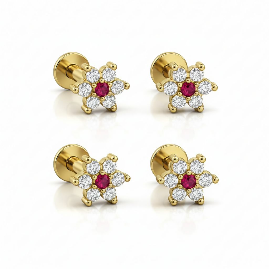 Set of four gold plated floral crystal labret piercing studs displayed together