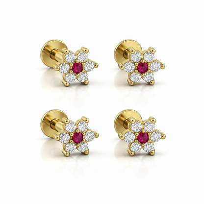 Set of four gold plated floral crystal labret piercing studs displayed together