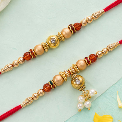 Bhai Bhabhi Kundan Rakhi Set with Red Thread, Gold Beads and Pearl Drop Accent Design