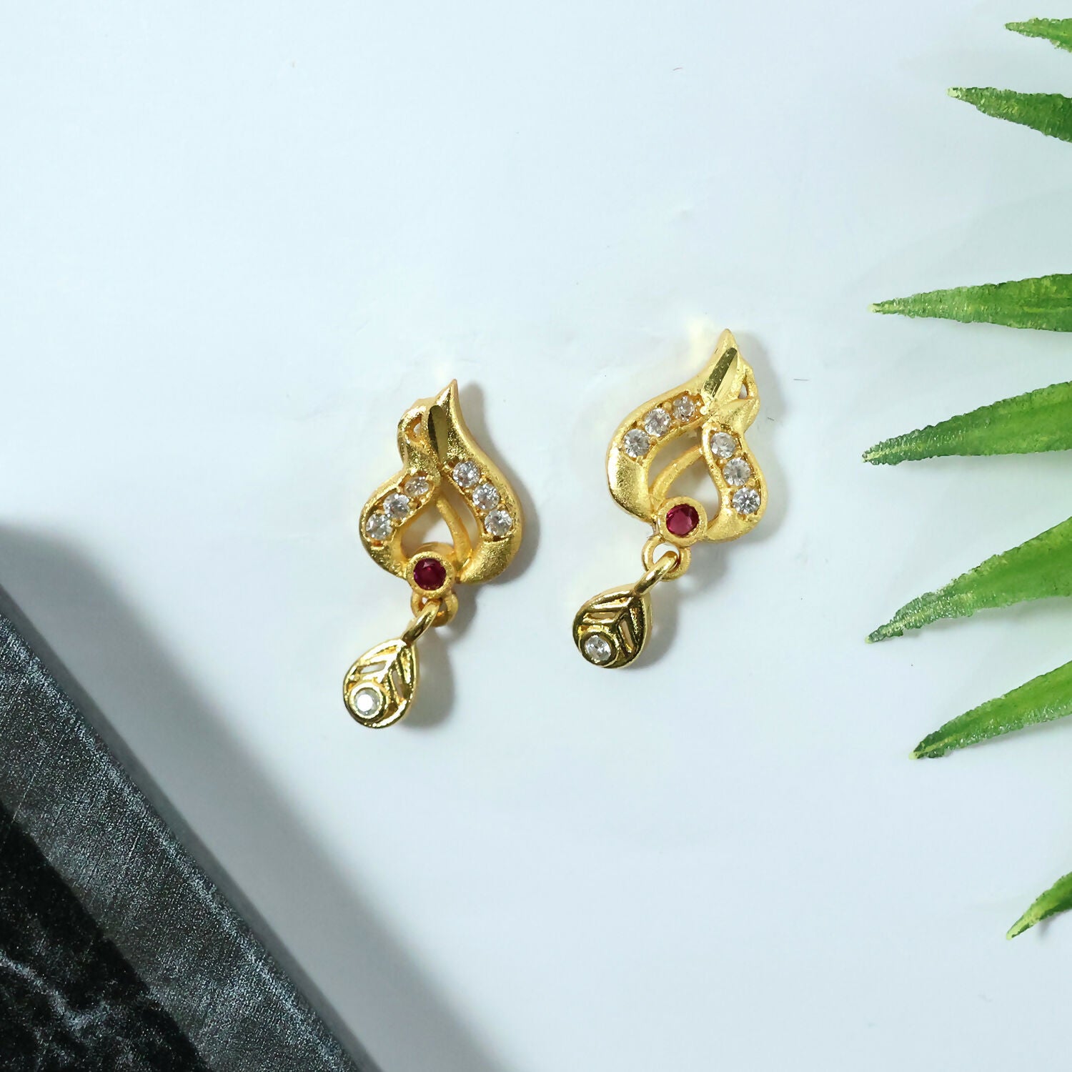 Classic Gold Tone Designer Leaf Earrings With Ruby Accent And Graceful Hanging Drop