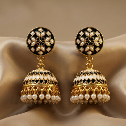 Close-up of black stud jhumka earrings showing golden and pearl details