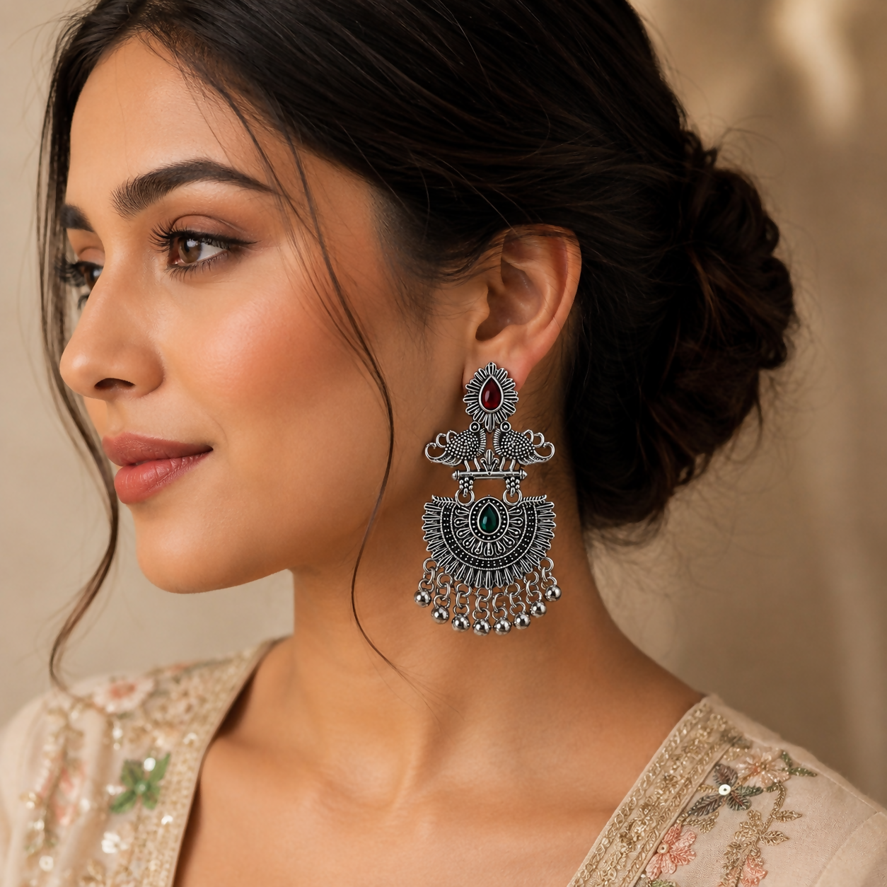 Oxidised statement jhumka earrings with dangling beads on a model.
