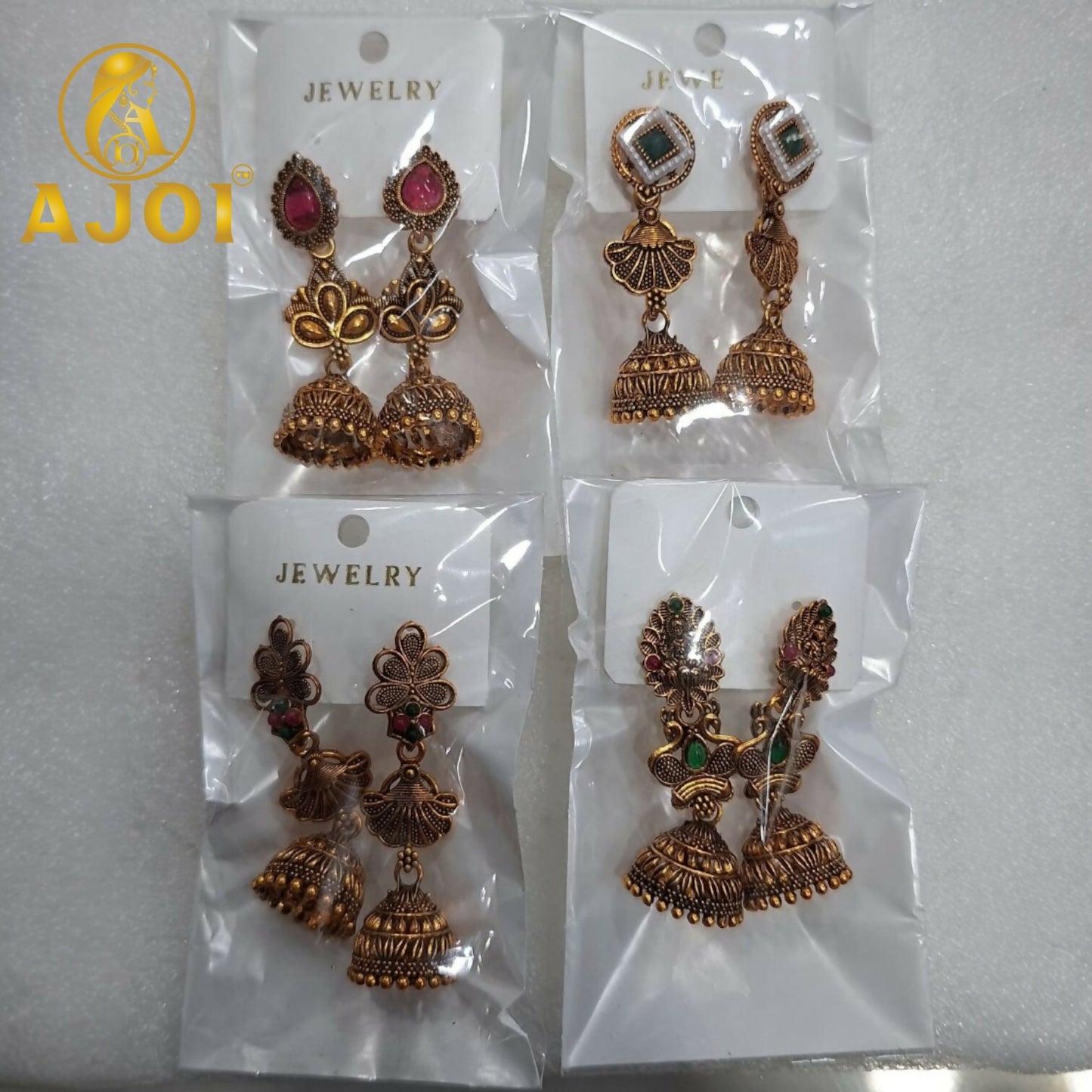 Antique Temple Gold Jhumka Earrings displayed on fabric