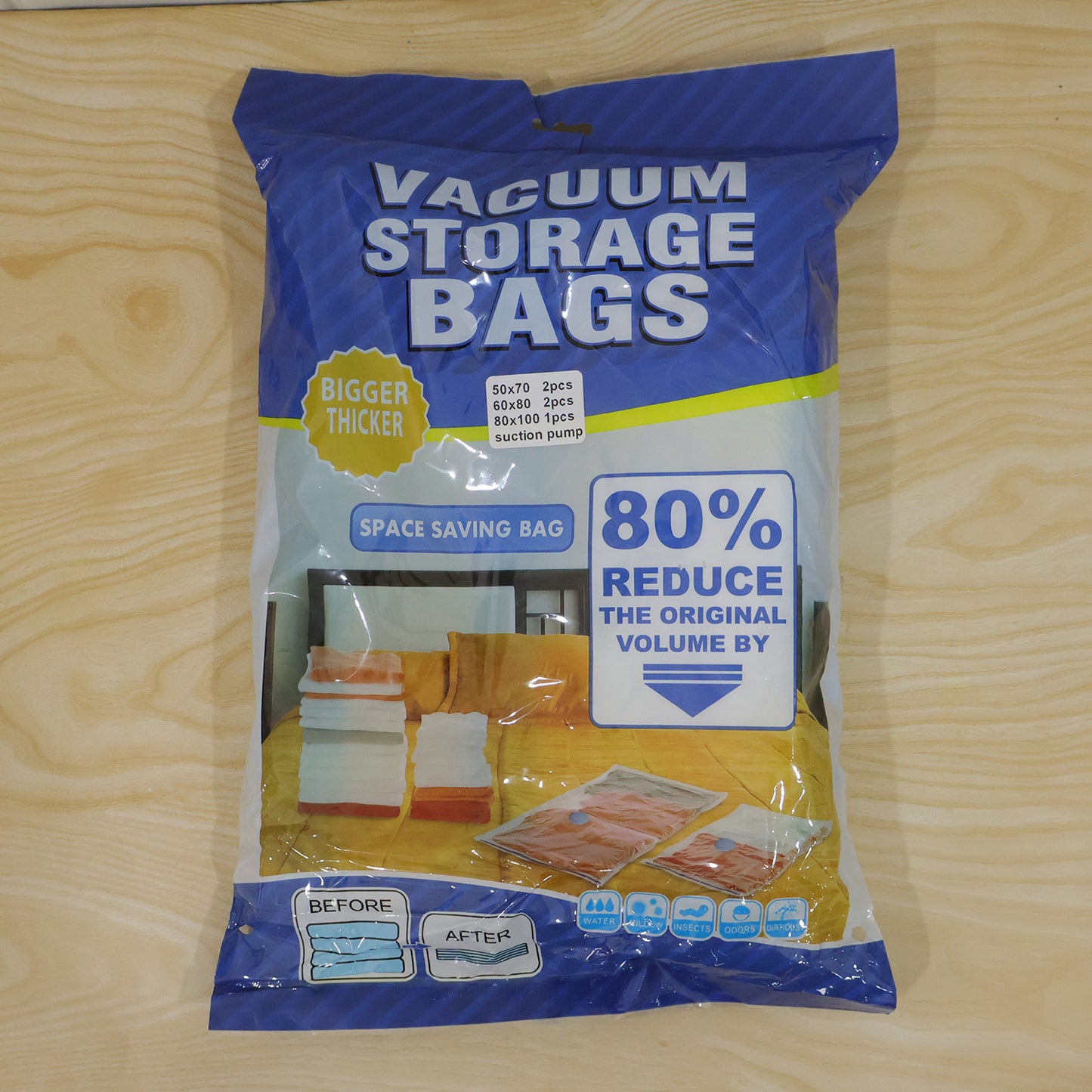 A blue and white retail package for "Vacuum Storage Bags" with text highlighting space-saving features and size details.