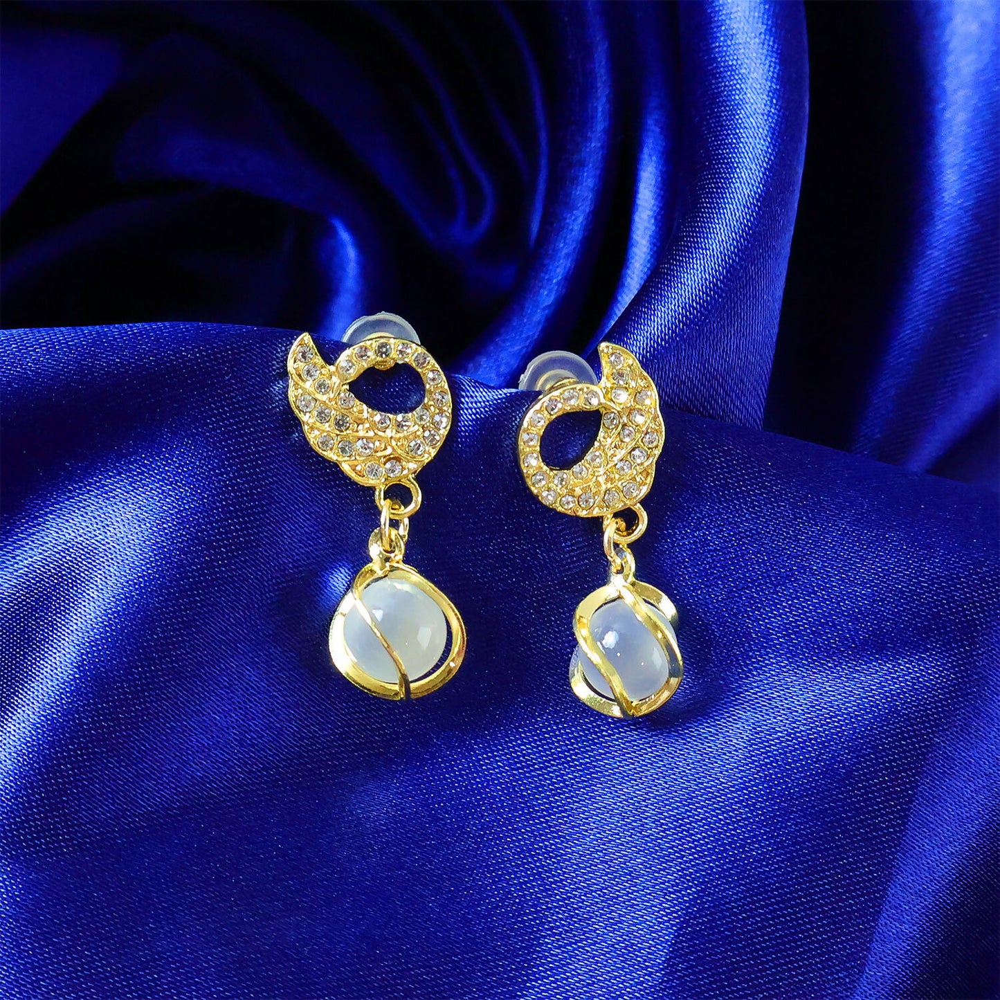 Close-up of designer swan earrings showing crystal details