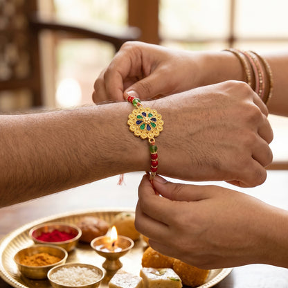 Gold Blue Flower Rakhi with Green Beads and Red Pearl Accents