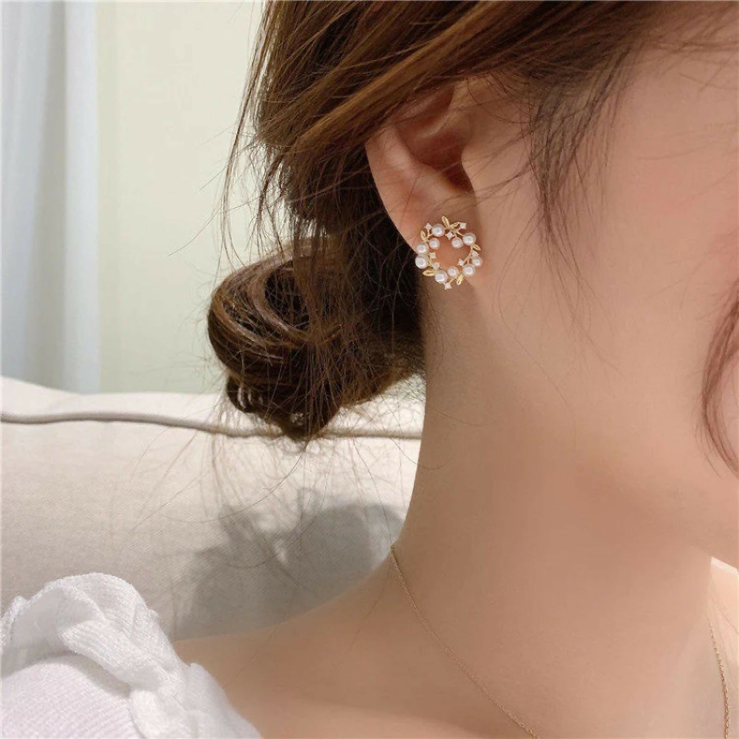 Close-up of pearl and crystal floral circle earrings