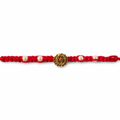 Red Braided Rakhi with Antique Gold Om Pendant and Lustrous Pearls