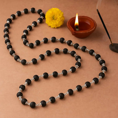 Kalungi Mala with premium matte black 6mm beads and silver flower spacers displayed elegantly