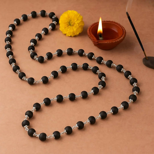 Elegant Kalungi Mala with matte black beads and silver spacers displayed