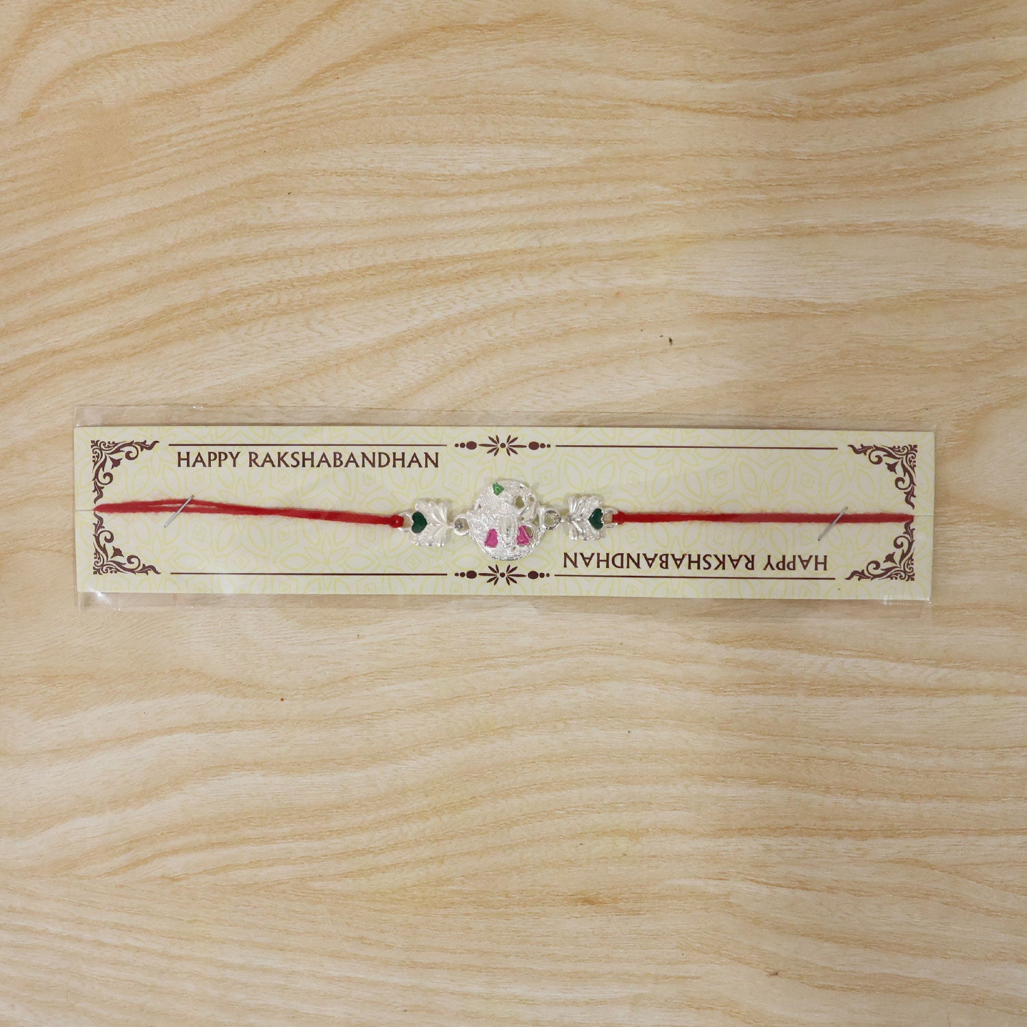 Silver Shrinathji Rakhi with Pink Green Stones and Elephant Charms