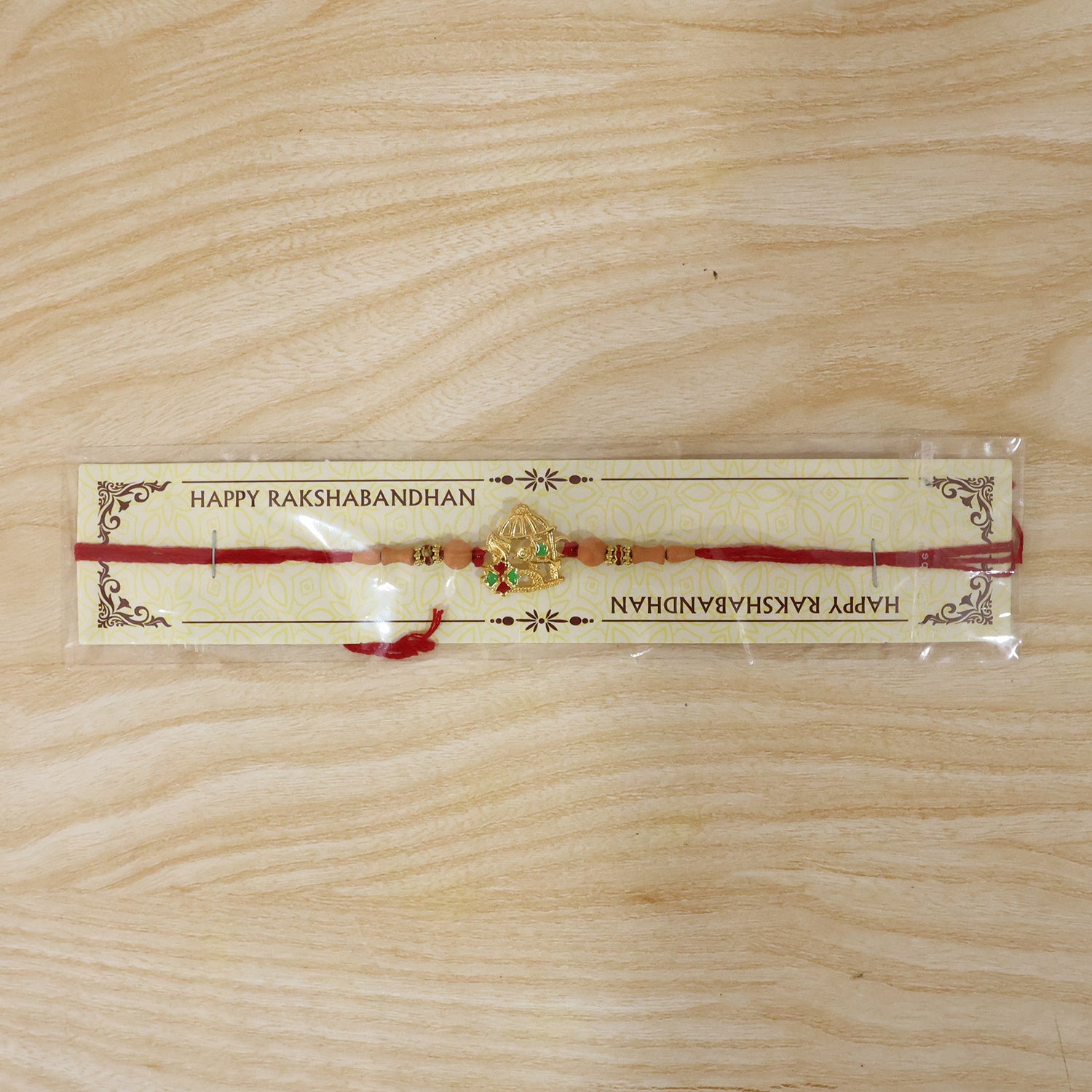 Golden Bow and Arrow Rakhi for Boys with Red Thread and Beads