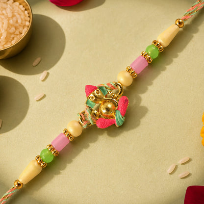 Gold Ganesha Charm Rakhi with Coral and Green Accents