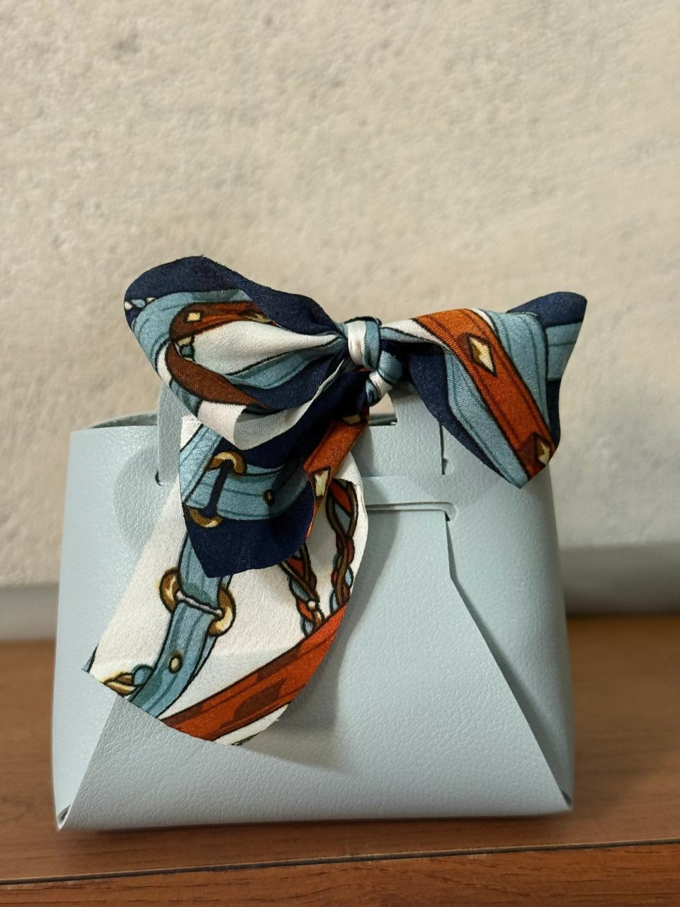 Mini handbag organizer with bow, angled top view