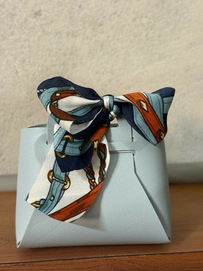 Mini handbag organizer with bow, angled top view