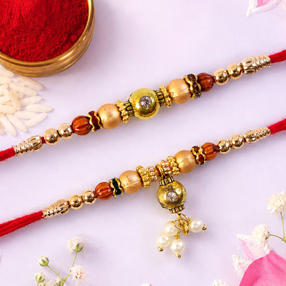 Bhai Bhabhi Kundan Rakhi Set with Red Thread, Gold Beads and Pearl Drop Accent Design