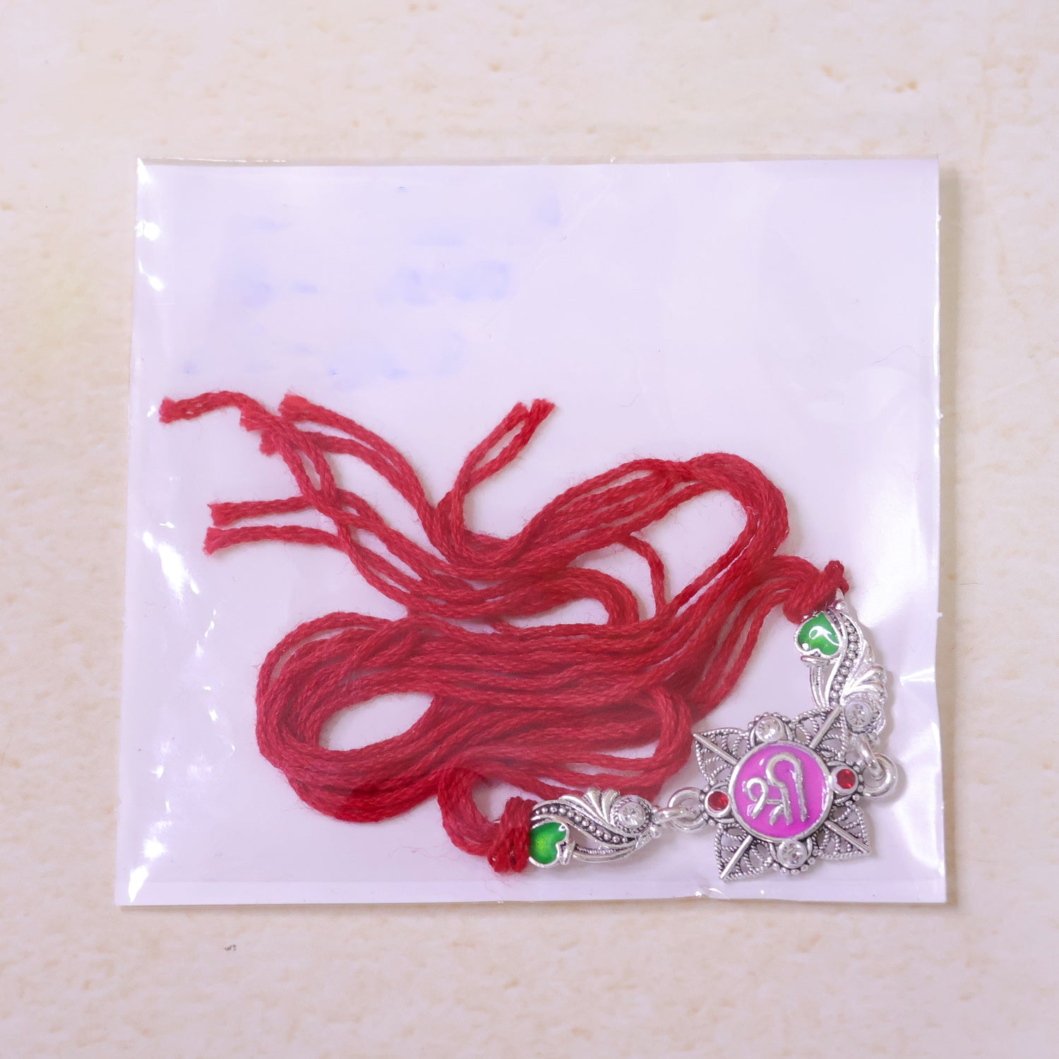 Silver-Toned Shree Rakhi with Pink Enamel, Crystal Accents & Designer Red Thread