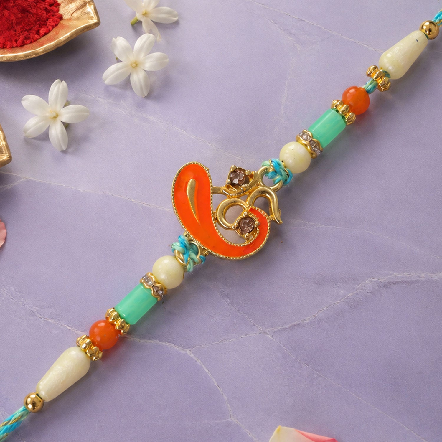 Traditional Rakhi with Om Symbol Charm and leaf detail in thread style for Gift Use