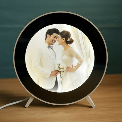 Modern round LED photo frame lamp illuminated on table