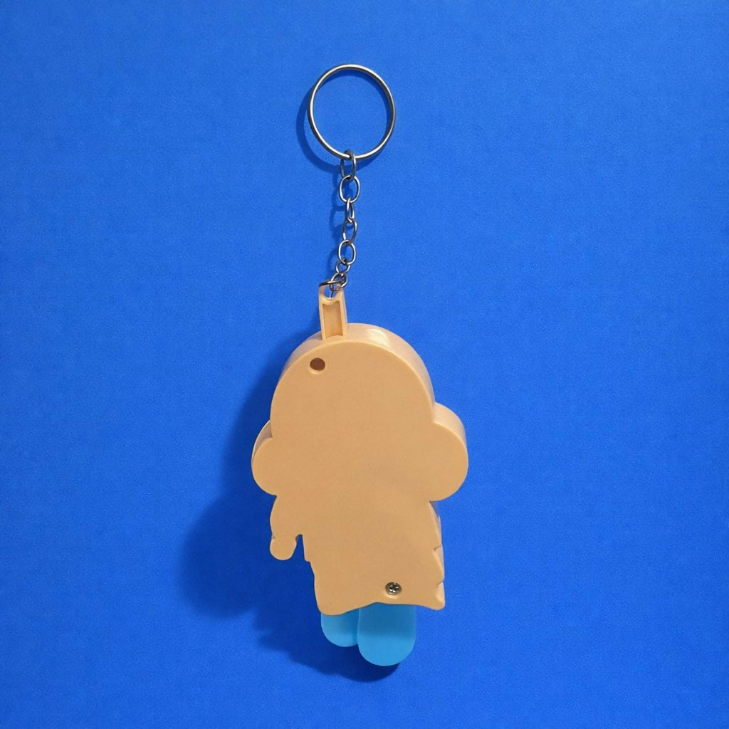 Cartoon boy keychain hanging from keys