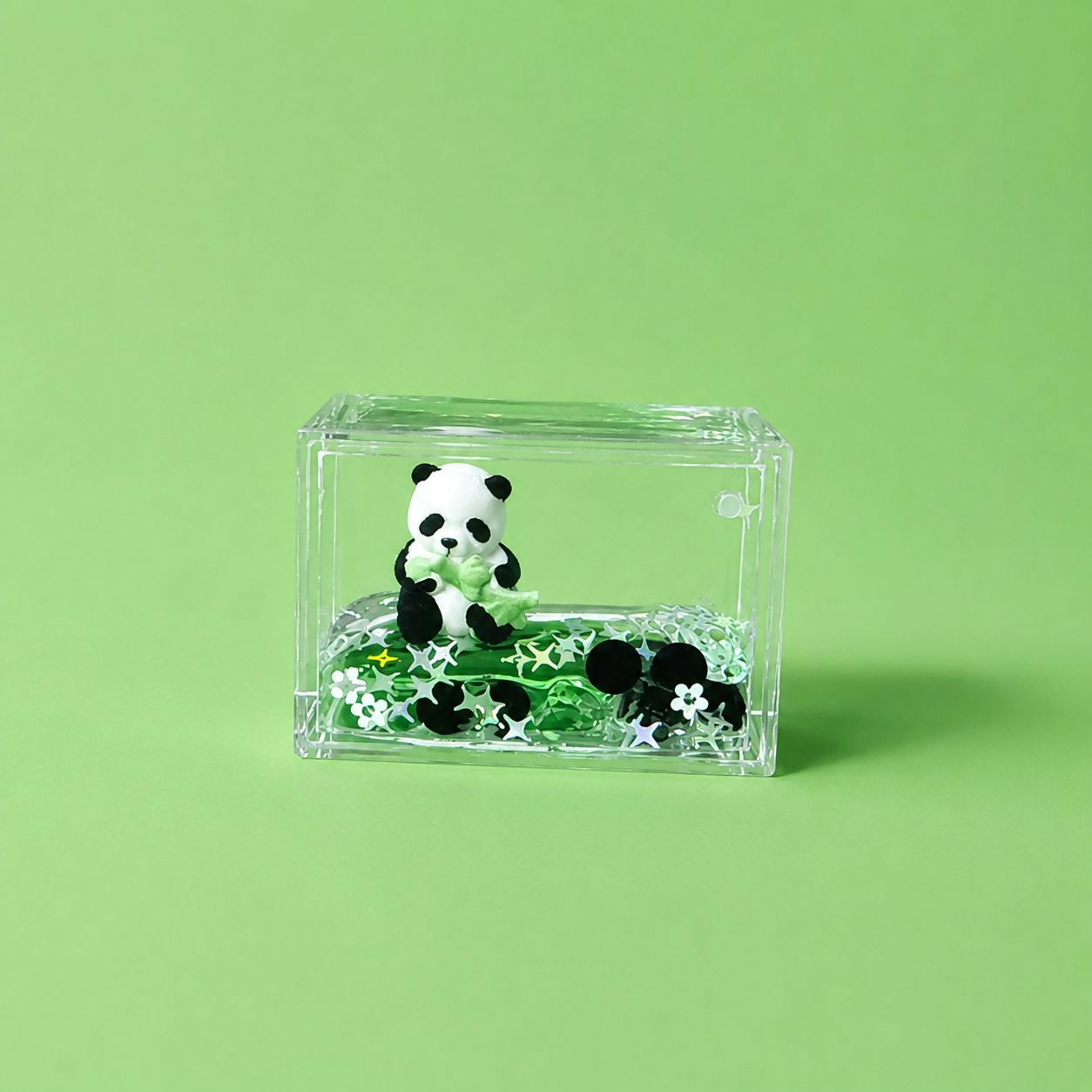Mini panda paper weight holding papers on office desk