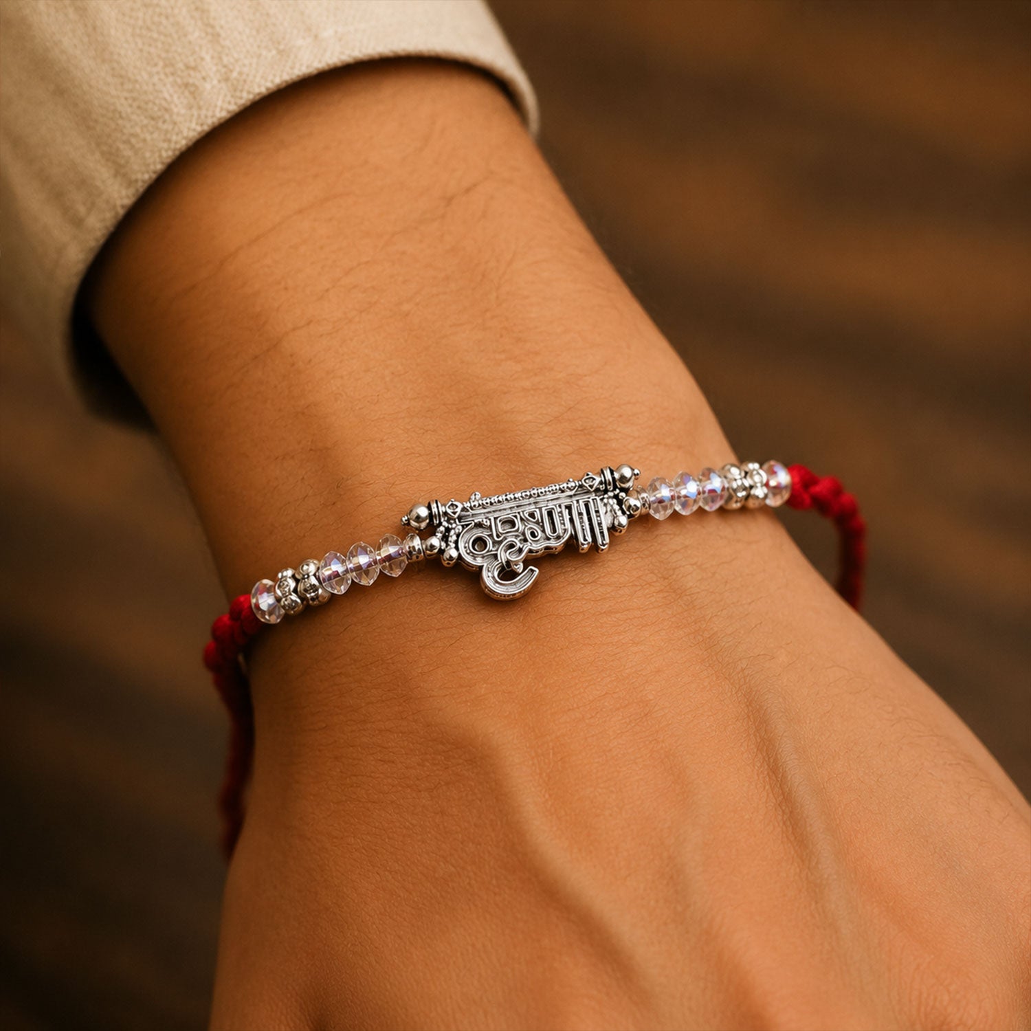 Silver Bhaiya Name Rakhi with Crystal Beads, Red Thread and Sparkling Detail
