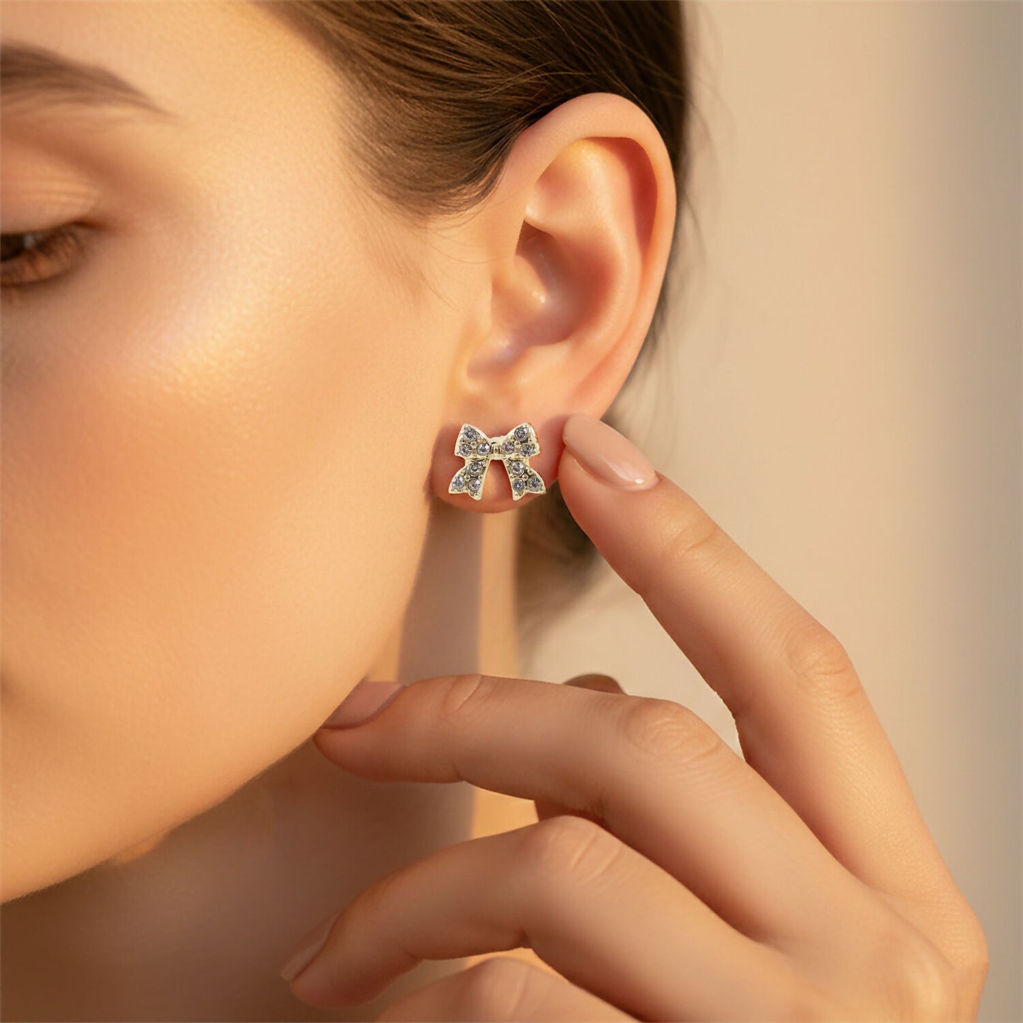 Gold plated crystal bow stud earrings pair