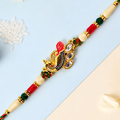 Diamond Shaped Kundan Pendant Rakhi with Peacock Feather Accent