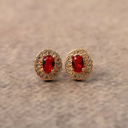 Side view of red stone stud earrings with elegant crystal halo and golden setting