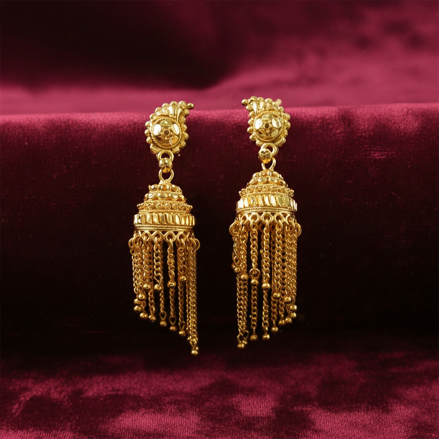 Traditional gold jhumka earrings with hanging chains